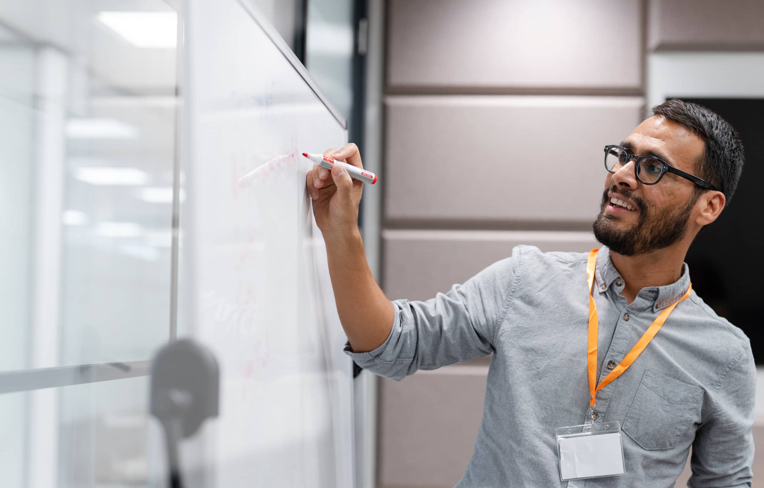 Project leader writing on whiteboard